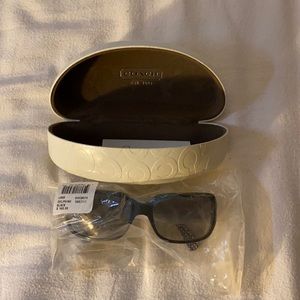 New Coach women’s Delphine black sunglasses.